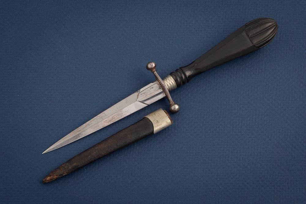 Small antique Dagger or Letter Opener with an unmarked double edge blade and an ebony handle. It is: Small antique Dagger or Letter Opener with an unmarked double edge blade and an ebonyhandle. It is accompanied by a period leather sheath with nickel silver throat.