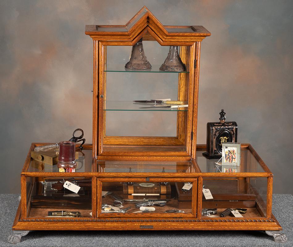 Unique quarter sawn oak and glass, claw foot, counter top Showcase. Manufactured by J.W. Winchester: Unique quarter sawn oak and glass, claw foot, counter top Showcase. Manufactured by J.W. Winchester Co., case has both front and rear loading doors with cathedral center display. Excellent finish and 
