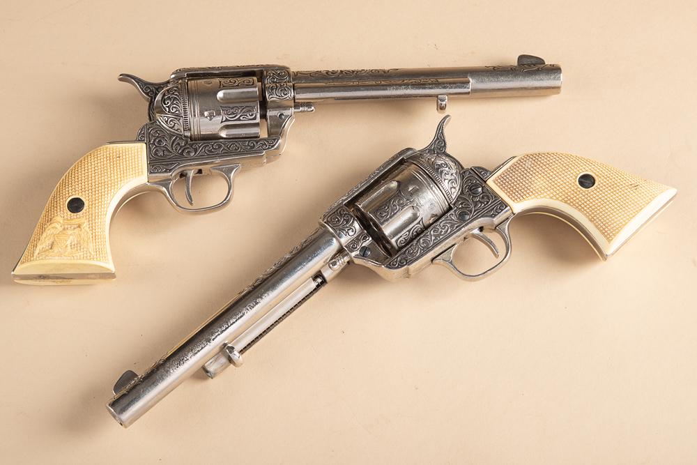 Matching pair of fancy Long Barrel Revolvers. These revolvers are Prop Guns and were used to: Matching pair of fancy Long Barrel Revolvers. These revolvers are Prop Guns and were used to simulate a pair of Colt revolvers, snake and eagle grips. This pair of prop guns will sell as one lot.