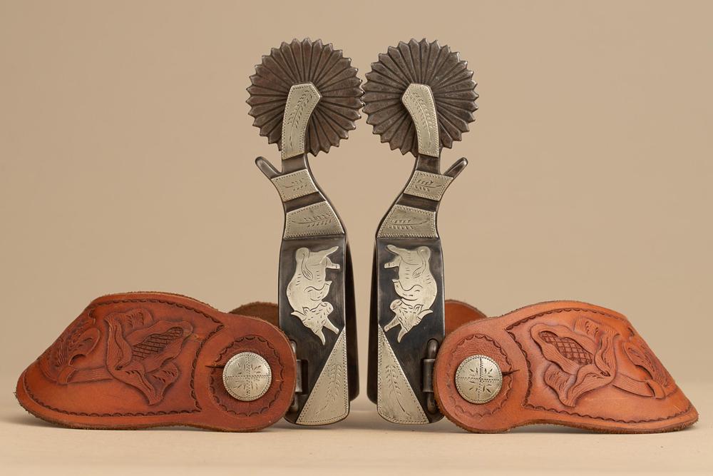 Showy pair of double mounted silver overlay Spurs by noted Texas Bit and Spur Maker Terry Alward,: Showy pair of double mounted silver overlay Spurs by noted Texas Bit and Spur Maker Terry Alward, #151, with hand engraved silver overlay of raging bull on one side and oval medallions on opposite hee
