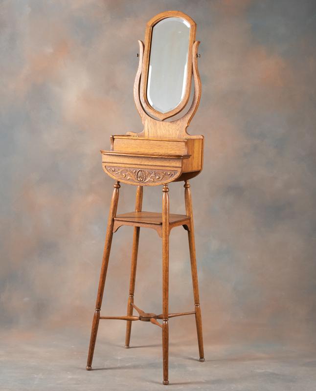 Unique antique quarter sawn oak, carved Shaving Stand, circa 1900-1910, shaped beveled glass mirror: Unique antique quarter sawn oak, carved Shaving Stand, circa 1900-1910, shaped beveled glass mirror and hinged lift top razor compartment. Stand measures 63" tall x 11" deep x 15 3/4" wide. Shaving St