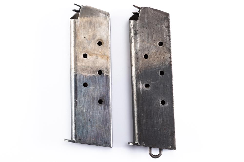 Two Magazines for a Model 1911. One is a 4th Model Lanyard Loop Magazine. The other is a WWI two: Two Magazines for a Model 1911. One is a 4th Model Lanyard Loop Magazine. The other is a WWI two tone made by the American Tin Co. Will be sold 2 x the bid.