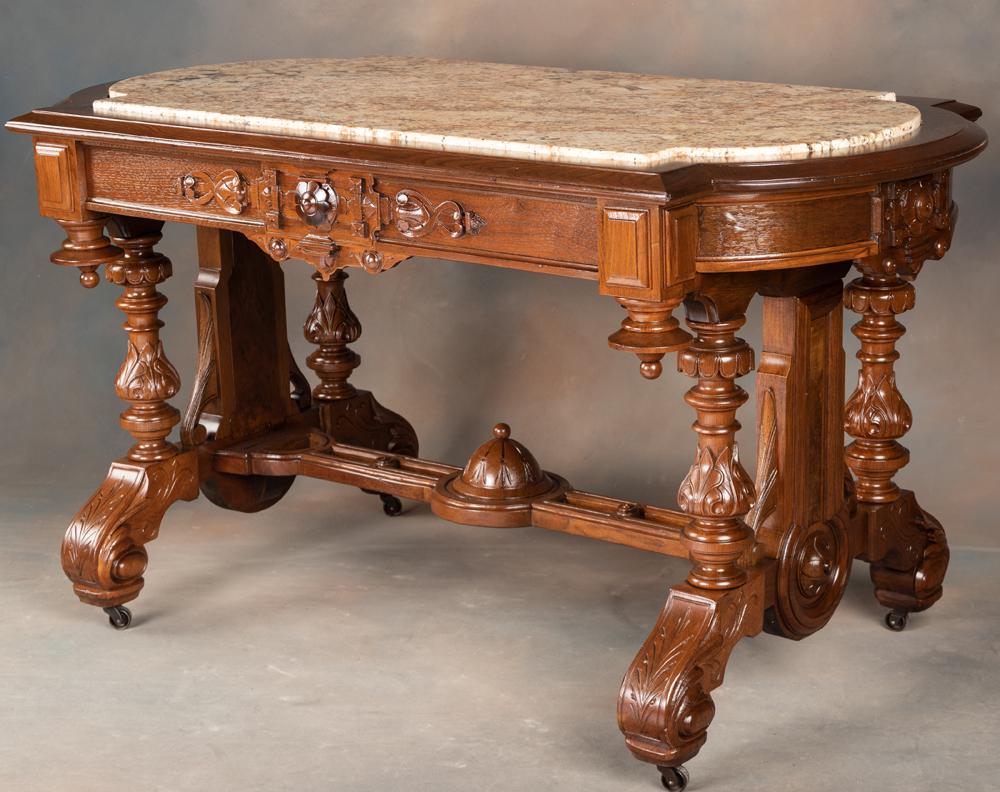 Massive American Victorian carved Walnut, marble top Library Table, circa 1870-1880s, with inset: Massive American Victorian carved Walnut, marble top Library Table, circa 1870-1880s, with inset marble top, beautiful hand carved column supports and ornate carved stretcher. Table has hide away draw