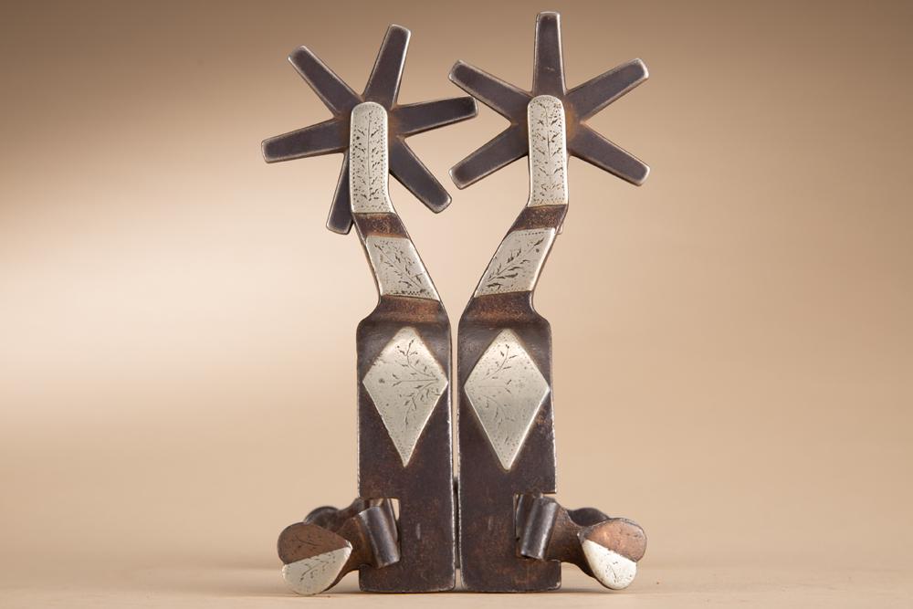 Pair of "NO. 400 / Made By J.O. BASS / Tulia, Tex" marked, single mounted Spurs, with split heart,: Pair of "NO. 400 / Made By J.O. BASS / Tulia, Tex" marked, single mounted Spurs, with split heart, swing buttons, 1" heel bands and large 6-point rowels. J.O. Bass (1871-1949).