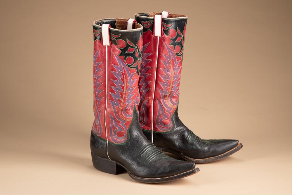 Slick pair of handmade Western Boots with 11" shaft and stove pipe tops. Multi-color, 8 line: Slick pair of handmade Western Boots with 11" shaft and stove pipe tops. Multi-color, 8 line stitching on tops and overlaid geometric design, fancy toe bug and roper heel. Approximately size 9. KING C