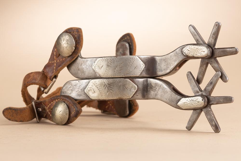 Pair of inside marked "O. Crockett" Spurs, single mounted, large multi-point rowels, engraved silver: Pair of inside marked "O. Crockett" Spurs, single mounted, large multi-point rowels, engraved silver diamond on heel bands and fixed etched buttons, sold with a pair of vintage leather straps. O. Croc