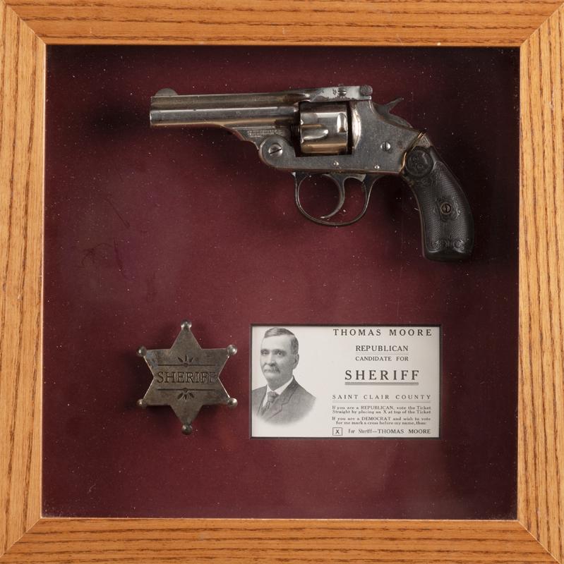 Framed collection of items to include: An Iver Johnson Tip Up Revolver, .32 caliber, SN F40605,: Framed collection of items to include: An Iver Johnson Tip Up Revolver, .32 caliber, SN F40605, nickel finish, 3" barrel, owl head grips. A replica 6-point star Sheriff Badge. A card marked "Thomas Mo