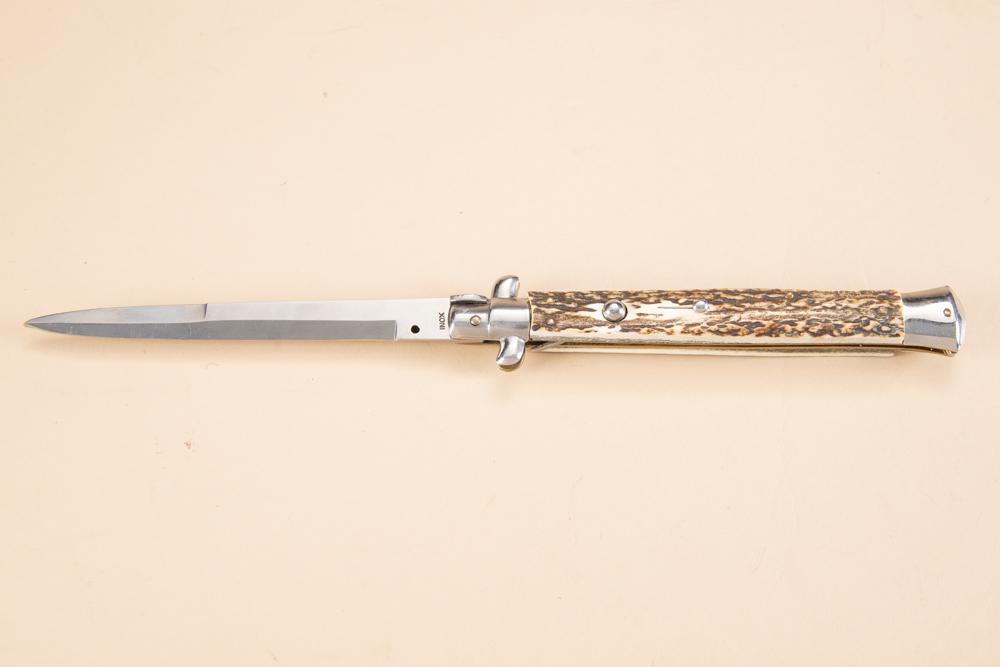 Large Switch Blade Knife with elk horn handles. Ricasso is marked, "Frank V Italy INOX." Knife has: Large Switch Blade Knife with elk horn handles. Ricasso is marked, "Frank V Italy INOX." Knife has 6" blade and measures overall 12 1/2" long. Knife is in very good condition.
