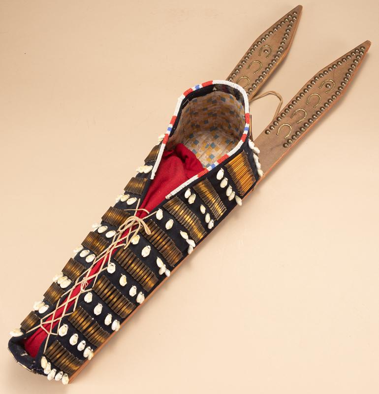 Beautiful tacked parfleche and trades cloth Native Cradle. Beautiful beading and shell design: Beautiful tacked parfleche and trades cloth Native Cradle. Beautiful beading and shell design attached to the trades cloth. Cradle measures 34 1/2" long.