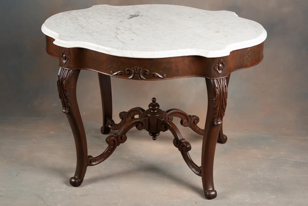 Beautiful early American Walnut Victorian turtle top, marble top Parlor Table, circa 1870s, with: Beautiful early American Walnut Victorian turtle top, marble top Parlor Table, circa 1870s, with ornately carved suspended stretcher and burl walnut skirt, O.G. shaped white marble top measures 42" lo