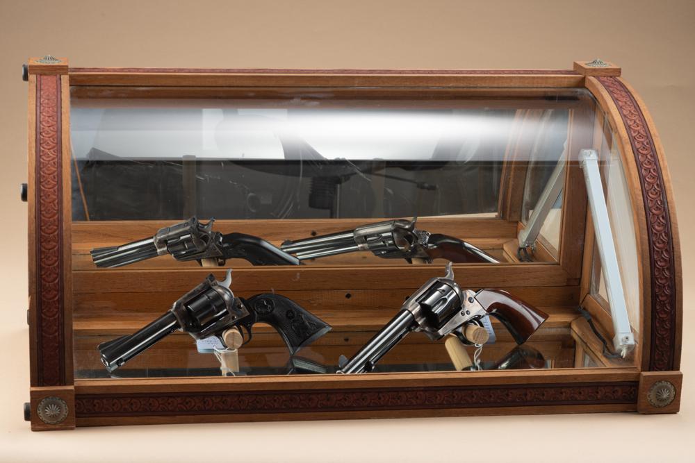 Curved glass counter top Showcase made by Texas artist the late Dave Karp, oak frame with tooled: Curved glass counter top Showcase made by Texas artist the late Dave Karp, oak frame with tooled leather border and inlaid conchos on corners, measures 27" wide x 12 1/2" tall x 12 1/2" deep with rear