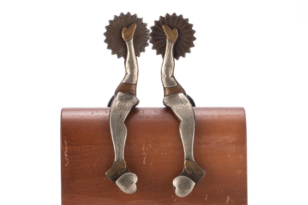 Pair of "McChesney" marked double mounted gal leg Spurs with hand engraved silver and copper: Pair of "McChesney" marked double mounted gal leg Spurs with hand engraved silver and copper overlay, fixed heart buttons. Scarce pattern, very good original condition. From the late Carolyn Jackson-H