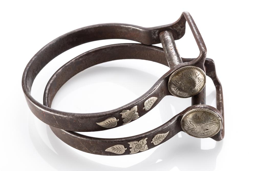 Pair of Kevin Burns silver mounted iron Ox Bow Stirrups with 1 1/2" hand engraved, domed silver: Pair of Kevin Burns silver mounted iron Ox Bow Stirrups with 1 1/2" hand engraved, domed silver conchos and silver floral overlay. Kevin Burns was a recipient of the prestigious Adolph Bayers Award fo