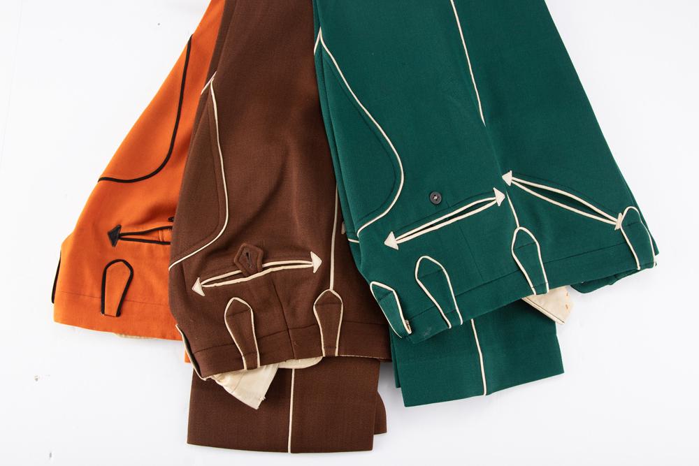 Three pair of vintage Nathan Turk Western Dress Slacks with piping and smiley pockets. All have some: Three pair of vintage Nathan Turk Western Dress Slacks with piping and smiley pockets. All have some light pest damage. Slacks are orange, brown and green. WILL BE SOLD AS ONE LOT. From the late Carol