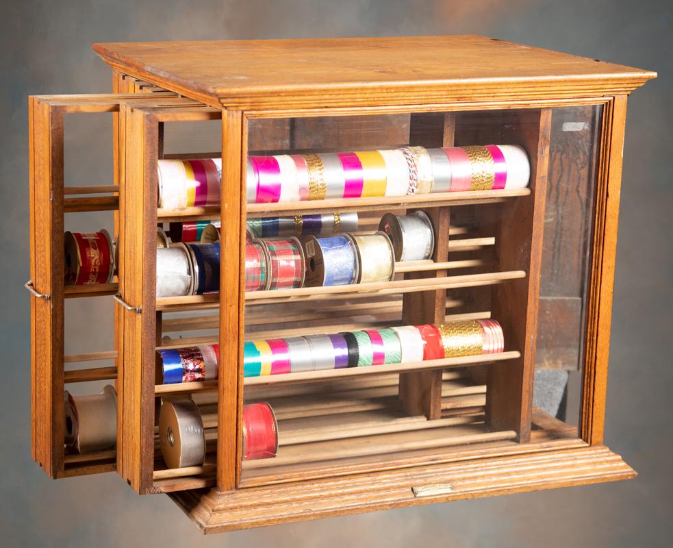 Antique oak case Ribbon Cabinet, circa 1890-1900, marked "A. N. Russell & Sons, Ilion, NY". Very: Antique oak case Ribbon Cabinet, circa 1890-1900, marked "A. N. Russell & Sons, Ilion, NY". Very good condition, cabinet measures 28 1/4" W x 22 1/4" D x 25 3/4" T. Although these were originally made