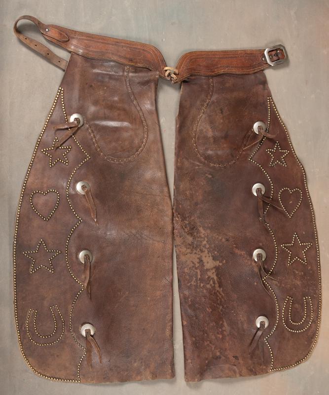 Pair of spotted Bat Wing Chaps, circa 1940s, with very desirable inside pockets. Spotted border with: Pair of spotted Bat Wing Chaps, circa 1940s, with very desirable inside pockets. Spotted border with stars, hearts and horse shoes. Nice original belt, leather is supple, shows some flaking. Trimmed w