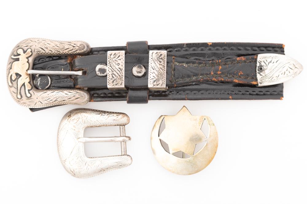 This lot consists of three items to include: An engraved 4-piece 3/4" Buckle Set marked "Don: This lot consists of three items to include: An engraved 4-piece 3/4" Buckle Set marked "Don Ricardo"; One "Sterling" marked 3/4" Buckle marked "Crockett"; One hand made Badge made from a Mexican coin