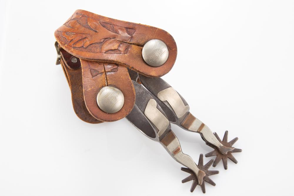 Pair of "Kelly Bros." marked double mounted gal leg Spurs with engraved scroll & mounted gal legs on: Pair of "Kelly Bros." marked double mounted gal leg Spurs with engraved scroll & mounted gal legs on one side, plain iron with engraved diamond on heel bands. Mounted with a pair of unique tooled two-
