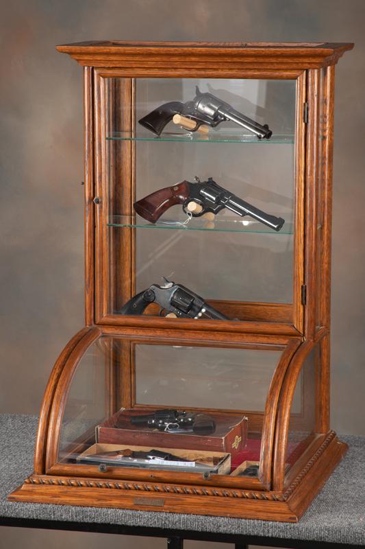 Very desirable oak case curved glass counter top model Showcase with factory bronze label "J.W.: Very desirable oak case curved glass counter top model Showcase with factory bronze label "J.W. Winchester". Case measures 33" T x 22" W x 19 1/2" D with both front and rear entry. Excellent finish an