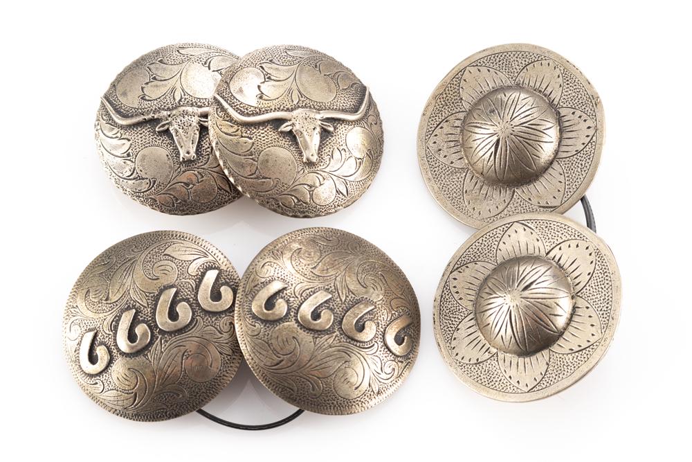 This lot consists of a collection of raised two inch silver conchos by noted Colorado Bit and Spur: This lot consists of a collection of raised two inch silver conchos by noted Colorado Bit and Spur maker the late Jack Ferguson. Marked "J F.", one pair of 6666, one pair with raised longhorns, and on