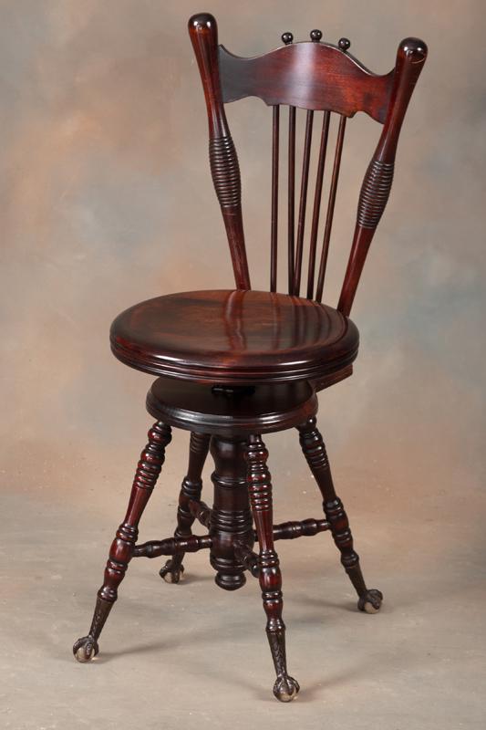 Antique mahogany high back Piano Stool, circa 1900, with Tiffany type brass claw and glass ball: Antique mahogany high back Piano Stool, circa 1900, with Tiffany type brass claw and glass ball feet, 14" round revolving seat with 35" high back. Nice finish and condition. KING COLLECTION