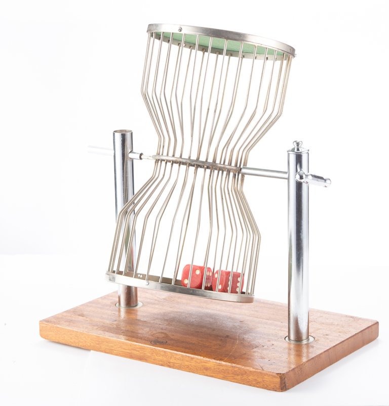 Vintage nickel silver Chuck-a-Luck, marked "St. Louis Carnival Supply Co., 15 3/4" cage mounted on a: Vintage nickel silver Chuck-a-Luck, marked "St. Louis Carnival Supply Co., 15 3/4" cage mounted on a wooden maker marked base. Base measures 17 1/2" L x 11 1/2" D x 19" overall T.