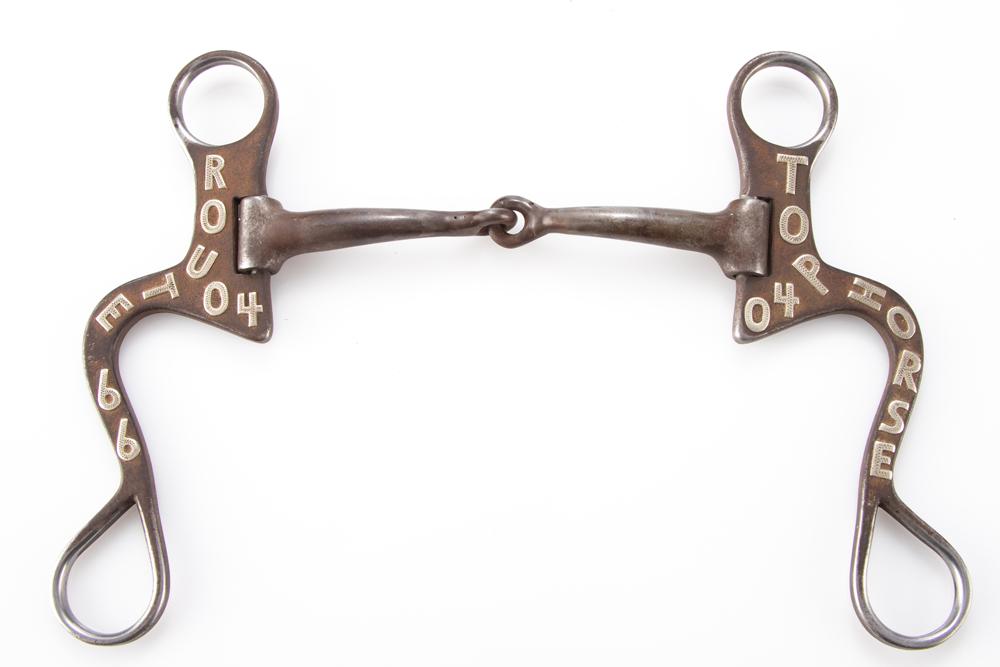 Iron Loose Jaw Bit, #468, by Silverton, Texas Bit and Spur Maker Wade Brannon. Bit has silver: Iron Loose Jaw Bit, #468, by Silverton, Texas Bit and Spur Maker Wade Brannon. Bit has silver overlay with names and dates. From the late Carolyn Jackson-Hardy Museum Estate Collection, Floydada, Texa