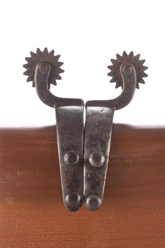 Pair of "OK" marked iron Spurs with drop shanks and double buttons, made by August Buermann. From: Pair of "OK" marked iron Spurs with drop shanks and double buttons, made by August Buermann. From the late Carolyn Jackson-Hardy Museum Estate Collection, Floydada, Texas.