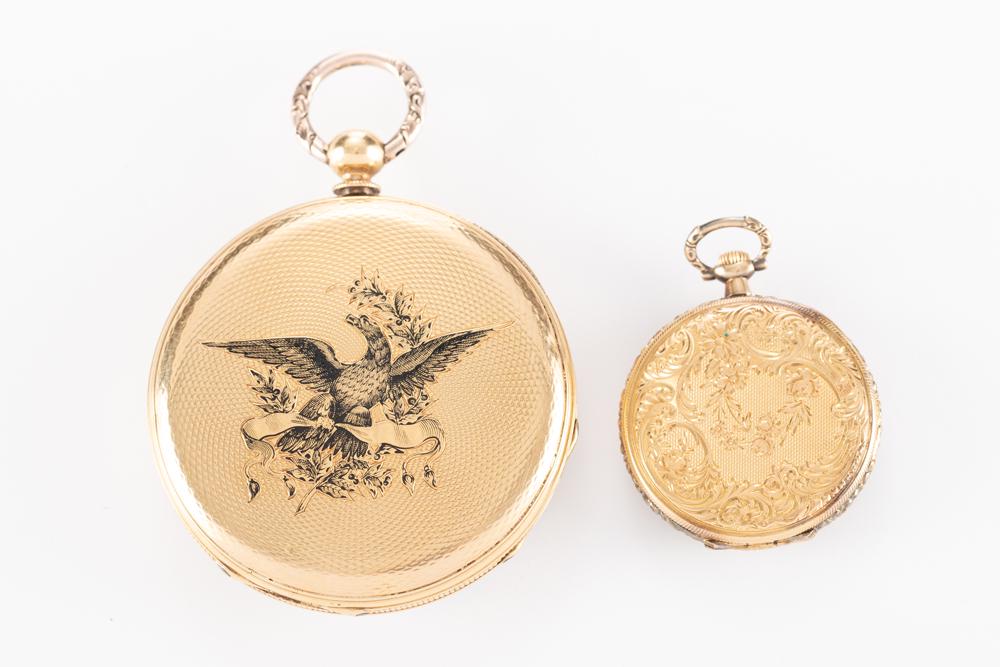 This lot consists of two antique Pocket Watches to include: One beautiful "18 KT" gold marked open: This lot consists of two antique Pocket Watches to include: One beautiful "18 KT" gold marked open face Ladies Lapel Watch with very ornate engraving on back, embossed dial with gold numbers, 17 jewel