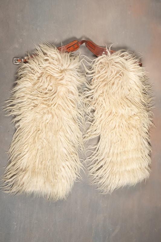 Excellent pair of white woolly Chaps with fancy tooled belt and two-piece Sunset Trails "Sterling": Excellent pair of white woolly Chaps with fancy tooled belt and two-piece Sunset Trails "Sterling" marked Buckle with keeper. Chaps are in excellent condition, leather and canvas lined, approximately 