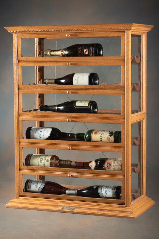Antique oak case Ribbon Cabinet, circa 1890s-1900, manufactured by A.N. Russell and Sons, Ilion,: Antique oak case Ribbon Cabinet, circa 1890s-1900, manufactured by A.N. Russell and Sons, Ilion, N.Y. U.S.A., in fine original finish and condition. This very desirable case is used as a wine cabinet.