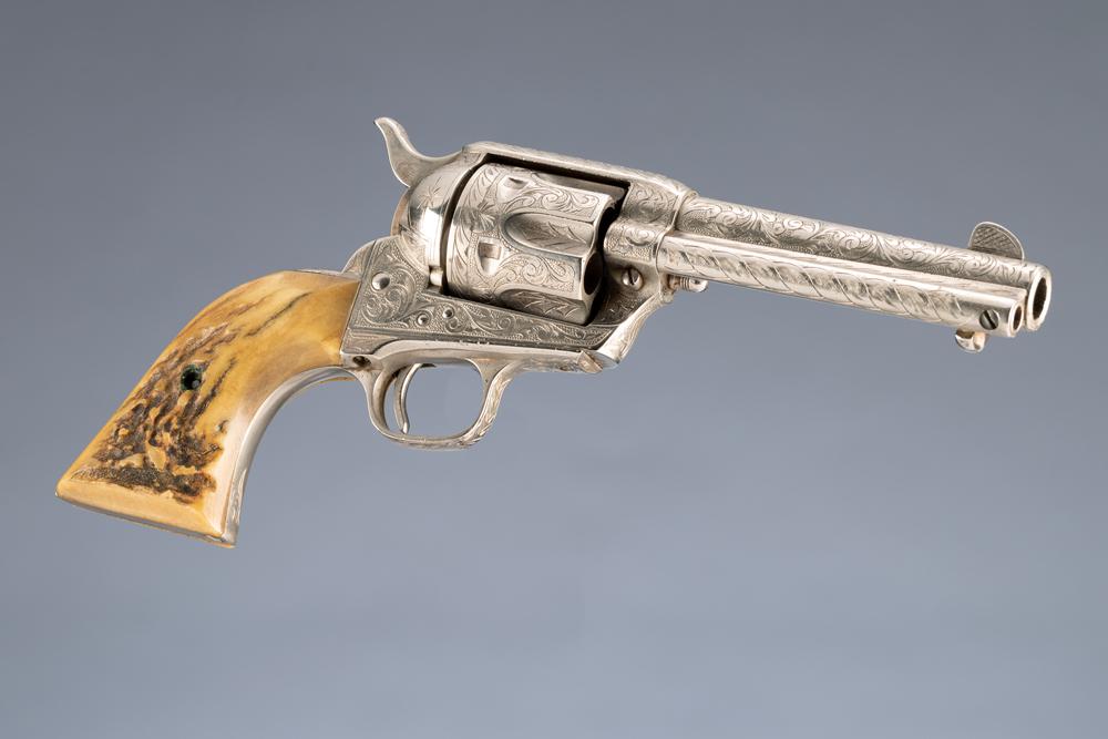 Cased engraved, Colt SAA Revolver, SN 344890, manufactured circa 1923. This is a .45 Colt caliber,: Cased engraved, Colt SAA Revolver, SN 344890, manufactured circa 1923. This is a .45 Colt caliber, 6-shot revolver with a 4 3/4” barrel, full coverage engraving, nickel finish with stag stocks. 