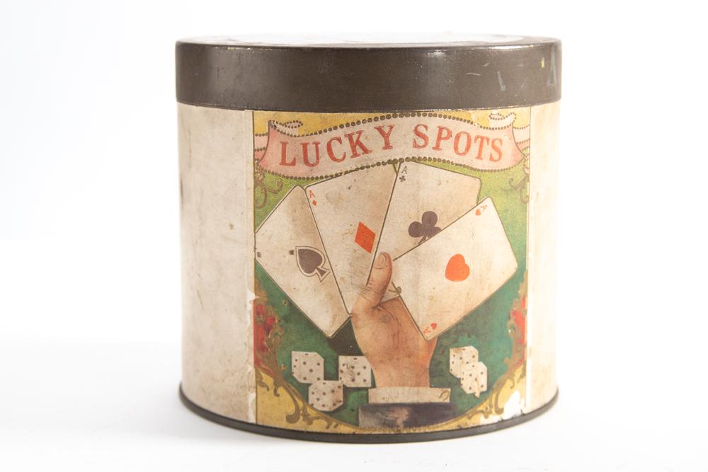 Antique Advertising Cigar Tin with paper label for Lucky Spots Manufacturers of Cigars and label on: Antique Advertising Cigar Tin with paper label for Lucky Spots Manufacturers of Cigars and label on back as well. Tin measures 5" T x 5 1/2" diameter.