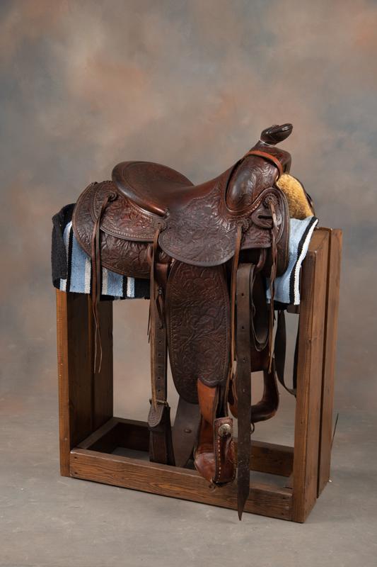 "H.H. Schweitzer, Matador, Texas" marked highly tooled vintage Saddle, 14" seat, 2 1/2" cantle,: "H.H. Schweitzer, Matador, Texas" marked highly tooled vintage Saddle, 14" seat, 2 1/2" cantle, maker marked on cantle and seat. Will be sold with saddle blanket and homemade saddle stand. FROM THE LA