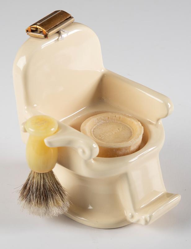 Most unusual vintage Razor & Brush Holder. Holder is porcelain in the shape of a barber chair,: Most unusual vintage Razor & Brush Holder. Holder is porcelain in the shape of a barber chair, complete with razor and brush. Holder measures 6" T x 4" base. BUDDY KING COLLECTION