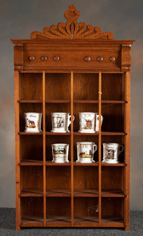 Very ornate antique oak hanging Barber Shop Mug Rack, factory Rack is designed to hold 20 Mugs,: Very ornate antique oak hanging Barber Shop Mug Rack, factory Rack is designed to hold 20 Mugs, excellent finish and condition, measures 44" T at center x 24" W x 8 3/4" D.