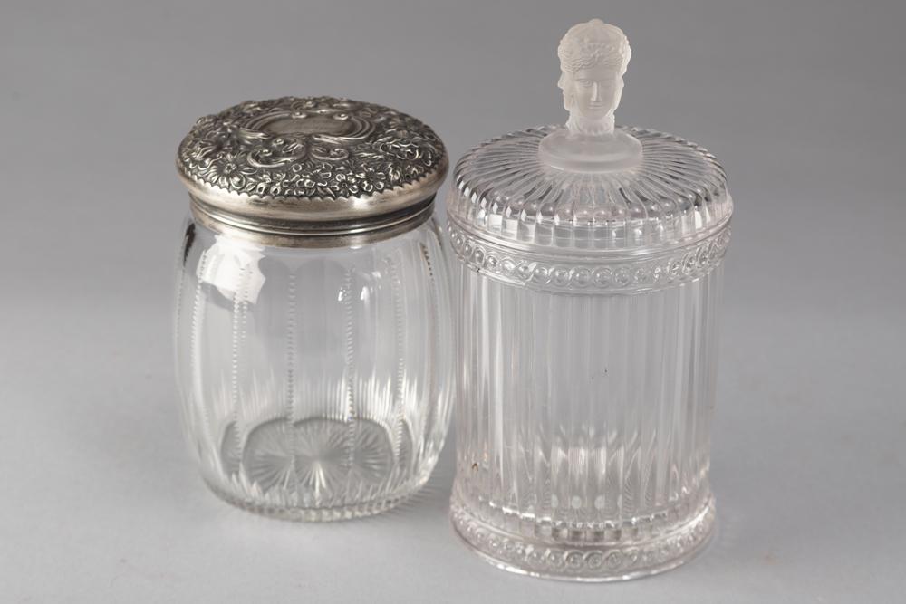 Two vintage glass Tobacco Jars. One is zipper cut that measures 6 1/2" T with embossed "Sterling": Two vintage glass Tobacco Jars. One is zipper cut that measures 6 1/2" T with embossed "Sterling" marked lid. The other is reeded pressed glass Tobacco Jar with reeded top and frosted triple face hand