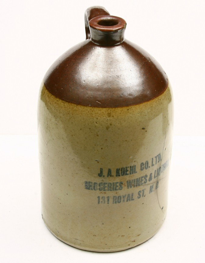 Early three gallon crock marked J.A. KOEHL CO. GRO: Early three gallon crock marked J.A. KOEHL CO. GROCRES, WINE & LIQUORS, 131 ROYAL ST., NEW ORLEANS w/ chipped spout and handle and hairlines in body. Note French Quarters.