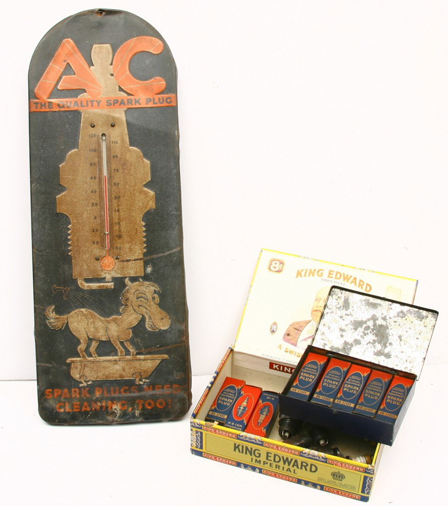 A C SPARK PLUG thermometer 8" x 21", shows surface: A C SPARK PLUG thermometer 8" x 21", shows surface ware w/ A C tin box and 5 spark plugs for FORD in boxes and 9 other early spark plugs. Sold as one lot.