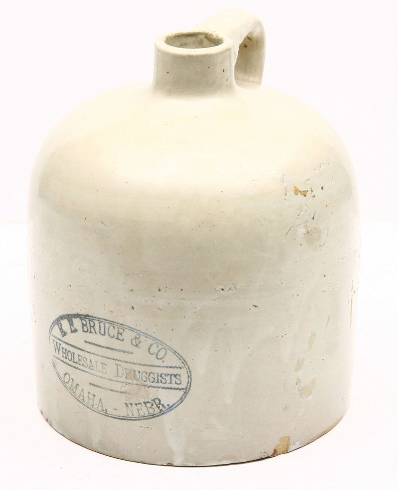 Early 9" drug store crock w/ handle for E.E. BRUCE: Early 9" drug store crock w/ handle for E.E. BRUCE & CO., OMAHA, NEBR., "Wholesale Druggists", one small flake at base, very good condition.