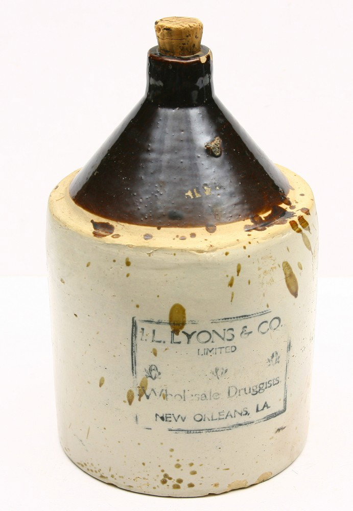 Early one gallon crock 12" tall for I. LYONS & CO.: Early one gallon crock 12" tall for I. LYONS & CO. " Wholesale Druggists" NEW ORLEANS, LA., some small chips on spout.
