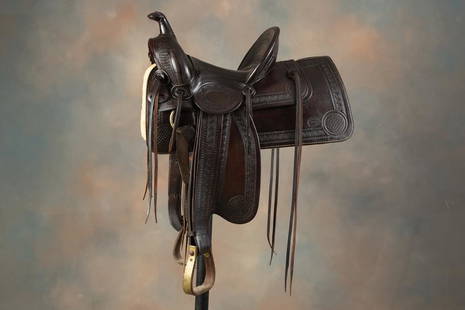 Vintage "Marks Bros. Sadd. Co., Omaha, Neb." marked high back Saddle, showing high condition with: Vintage "Marks Bros. Sadd. Co., Omaha, Neb." marked high back Saddle, showing high condition with finely tooled borders, 14" seat, 5" cantle, wooden ox bow stirrups, rich original brown color and