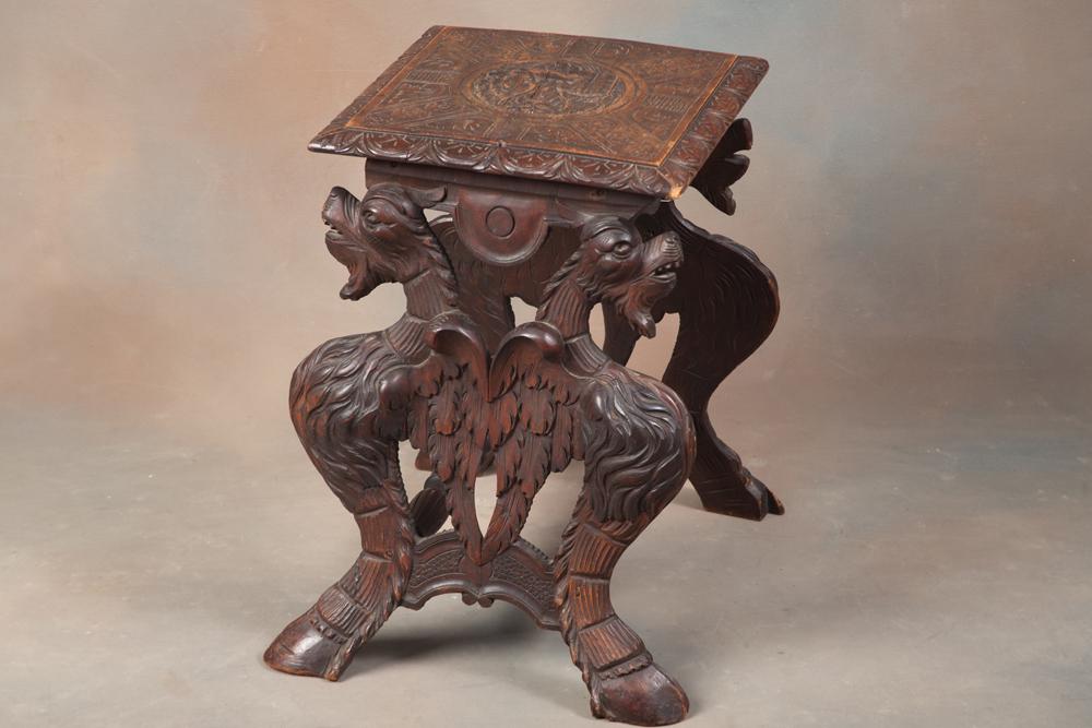 Highly carved wooden JardiniÃ¨re Stand with carved winged lions on each end and full carved top. Top: Highly carved wooden JardiniÃ¨re Stand with carved winged lions on each end and full carved top. Top has age separation at center. BUDDY KING COLLECTION
