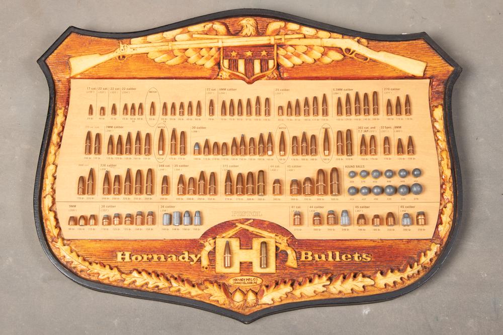 Shield shaped Hornady Bullet Board with 119 Bullets, measuring 20 1/4" W x 15 3/4" T. BUDDY KING: Shield shaped Hornady Bullet Board with 119 Bullets, measuring 20 1/4" W x 15 3/4" T. BUDDY KING COLLECTION