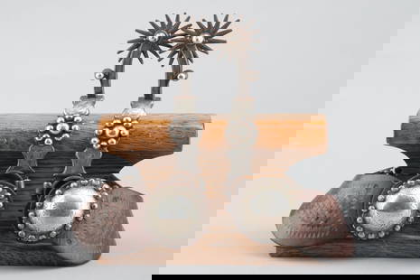 Fine pair of "G.S. Garcia, Elko, Nevada" marked single mounted Spurs with beautiful hand engraved: Fine pair of "G.S. Garcia, Elko, Nevada" marked single mounted Spurs with beautiful hand engraved silver inlay and overlay shanks and heel bands, chap guards, multi-point 2" rowels and heel chains.