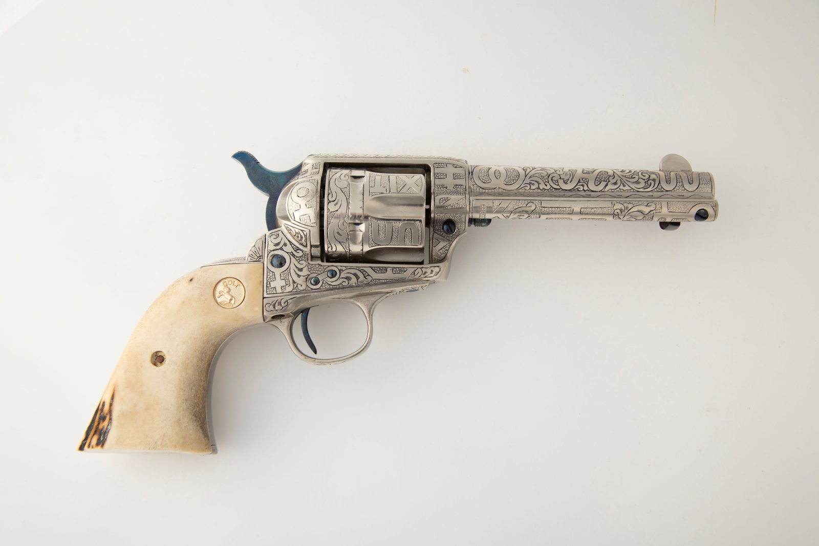 Fine Colt SAA Revolver engraved by Texas Master Engraver David Wade Harris, .44-40 caliber, SN: Fine Colt SAA Revolver engraved by Texas Master Engraver David Wade Harris, .44-40 caliber, SN 241354, manufactured 1903, 3 3/4" barrel, nickel finish with fire blue screws, full coverage engraved wit