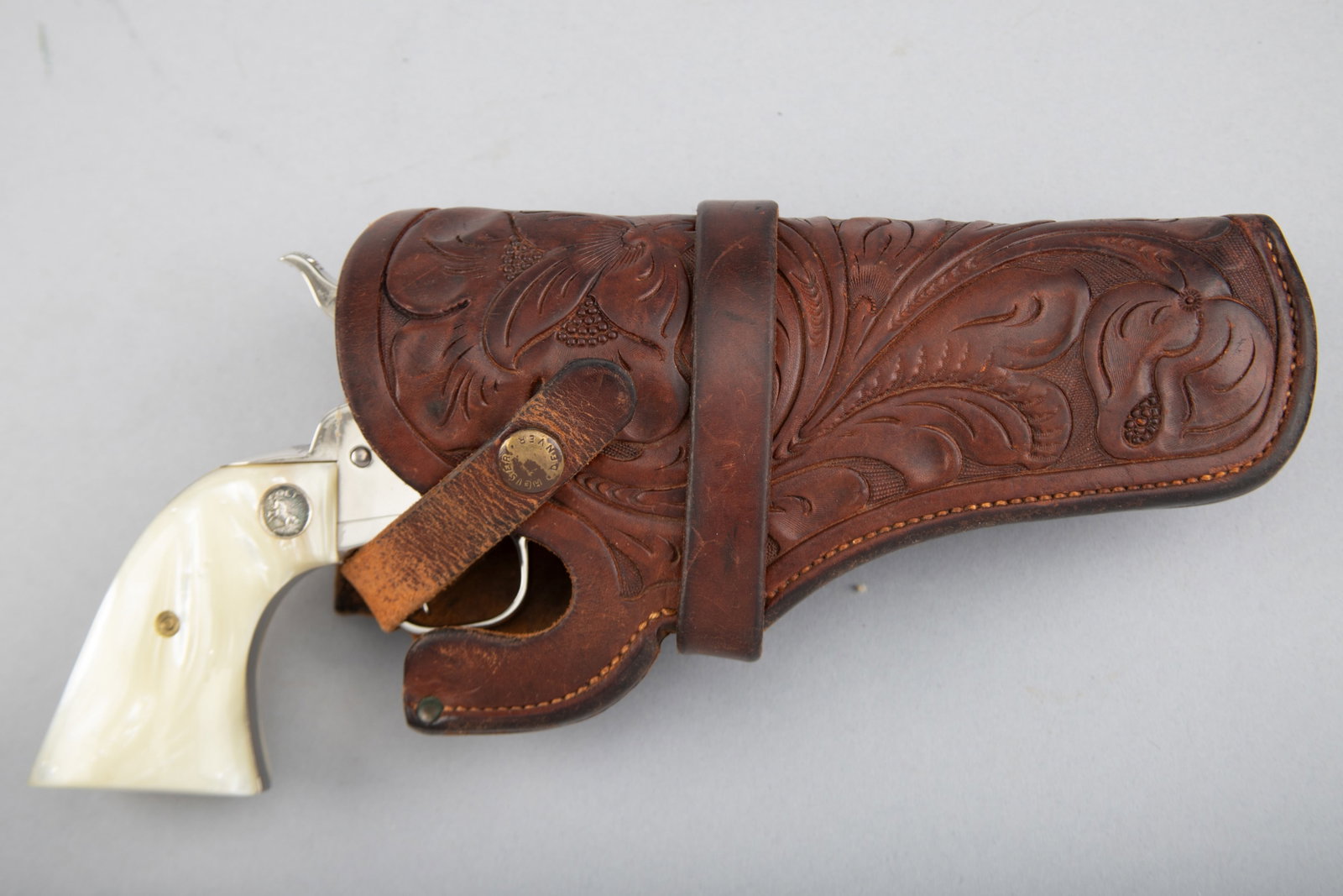 "H.H. Heiser, Denver Colo." marked fine tooled single loop Holster, catalog # 1716, for a 4 3/4" SA: "H.H. Heiser, Denver Colo." marked fine tooled single loop Holster, catalog # 1716, for a 4 3/4" SA Revolver. REVOLVER NOT INCLUDED. THE LATE MICHAEL HUTRYA ESTATE, WEST, TEXAS.