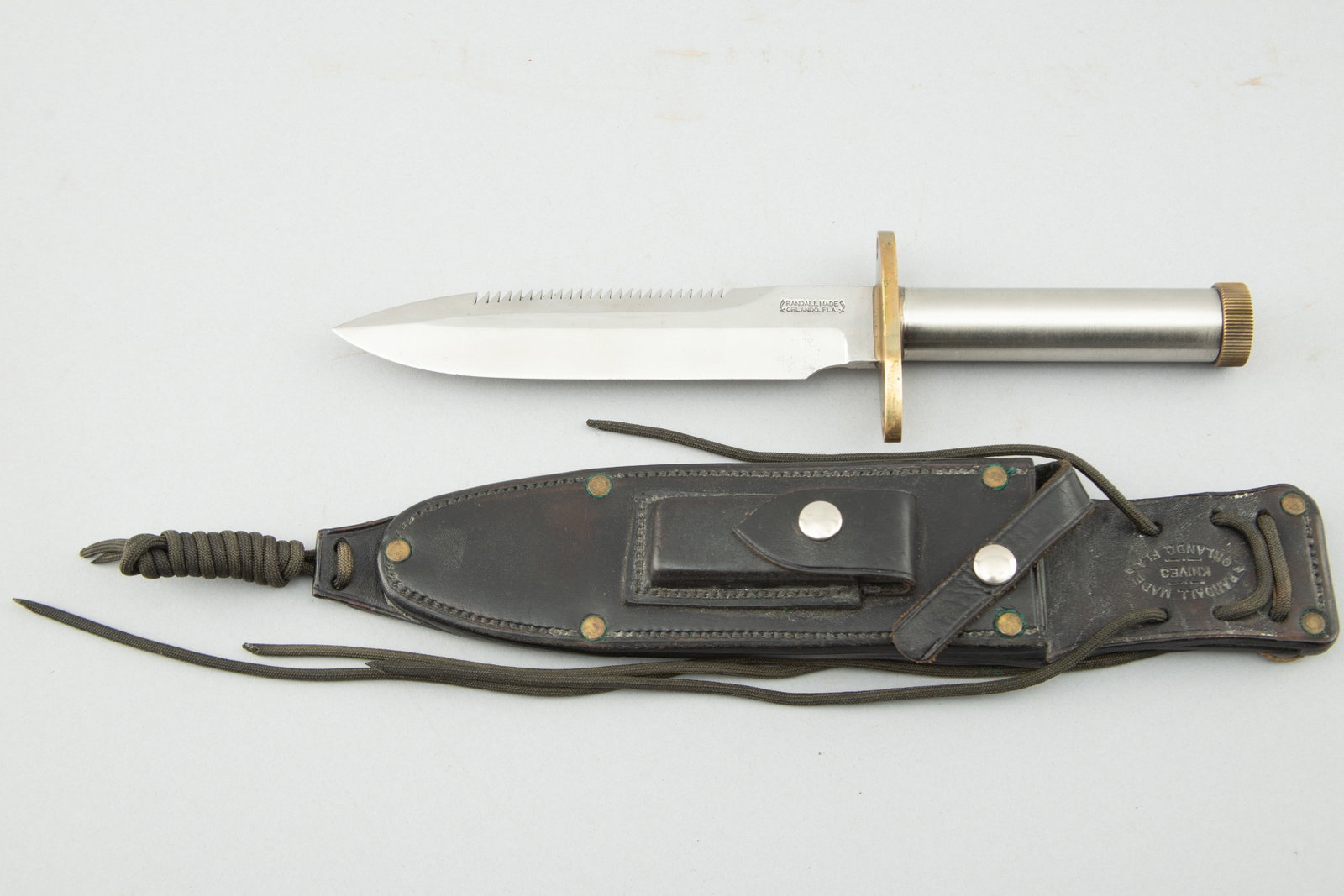 "Randall" marked Survival Knife Model 18-7 1/2, blade measures 7 1/2" with serrated area on top, 12: "Randall" marked Survival Knife Model 18-7 1/2, blade measures 7 1/2" with serrated area on top, 12 1/2" overall, heavy cross guard, stainless handle with storage compartment. Sold in its original "Ra