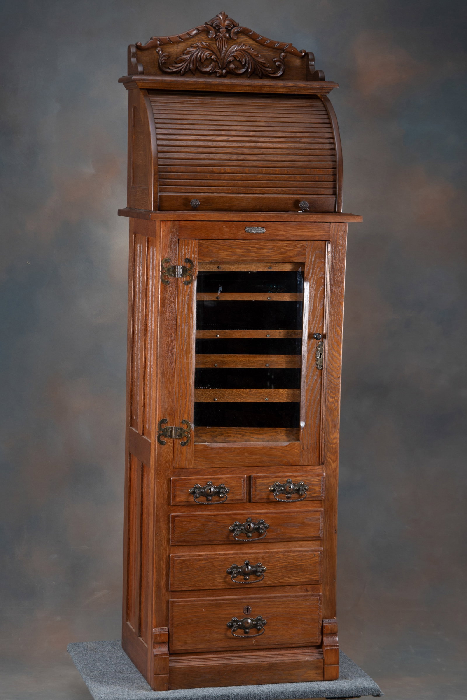 Beautiful antique oak roll front, multi-drawered Dental Cabinet marked "The Harvard Co., Canton,: Beautiful antique oak roll front, multi-drawered Dental Cabinet marked "The Harvard Co., Canton, Ohio", circa 1910, with metal label on front. Cabinet measures 77" T x 24 3/4" W x 18" D, with removabl