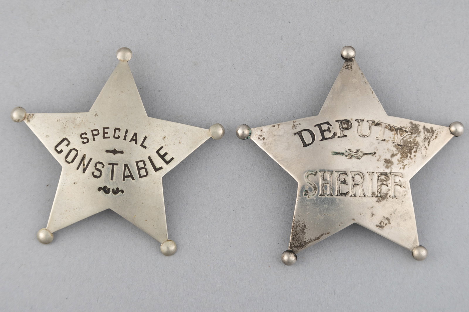This lot consists of two Badges: (1) Deputy Sheriff 5-point ball star Badge, 2 7/8" across points.: This lot consists of two Badges: (1) Deputy Sheriff 5-point ball star Badge, 2 7/8" across points. Turn of the Century. (2) Special Constable 5-point ball star Badge, 2 3/4" across points. Hall marked